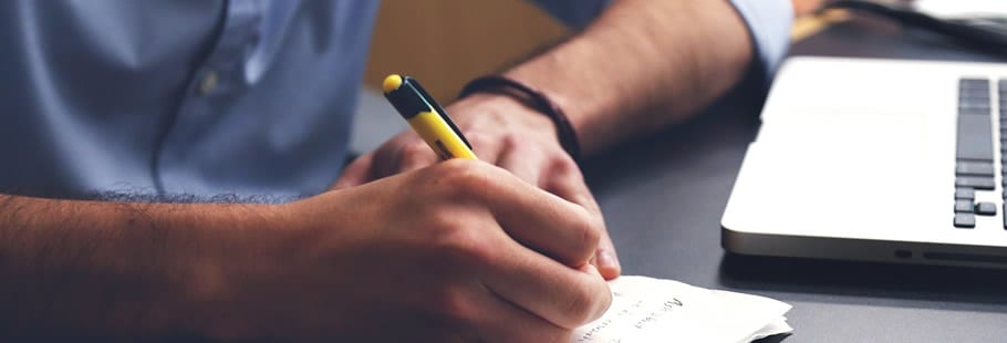 5 Things a Good PhD Research Proposal Doesnt Need to Be Man writing notes with laptop