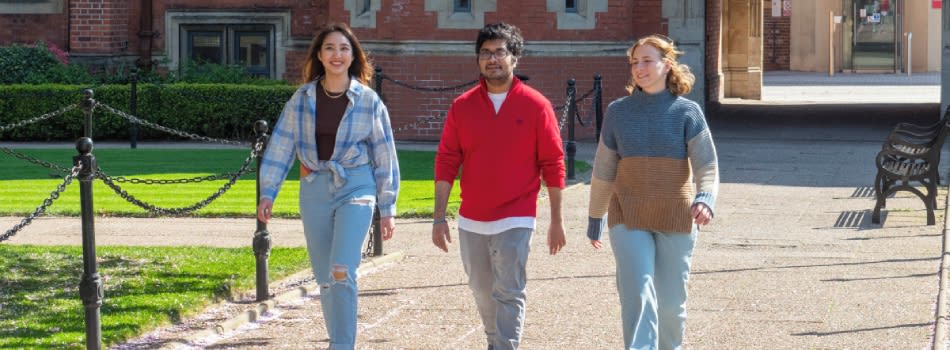 3 students walking outside the campus