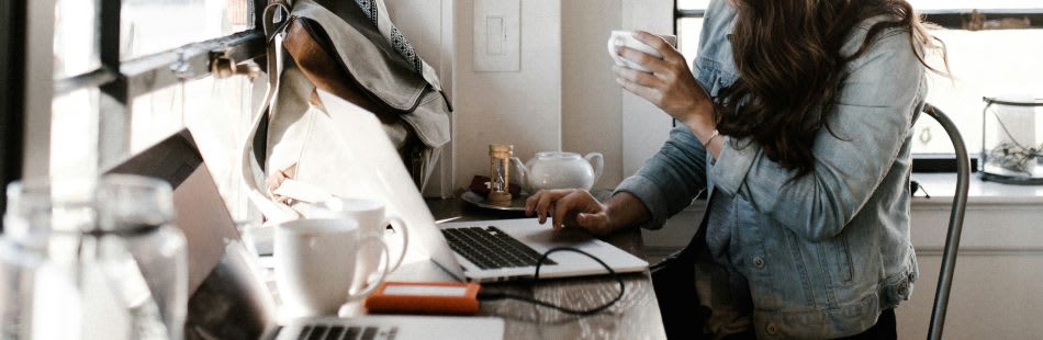 Woman in coffee shop working on laptop