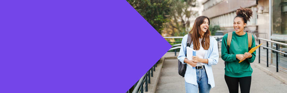 Two female students walking and talking