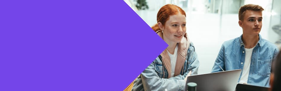 A female and male student talking whilst studying
