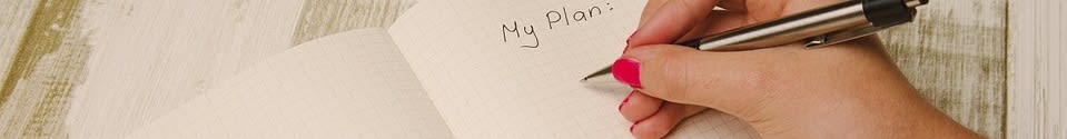 Womans hand with pen, writing My plan: in notebook