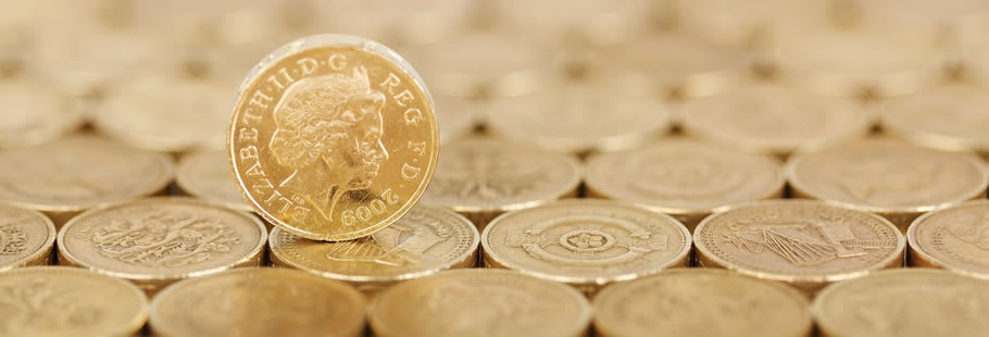 Pound coin raised up on pound coins