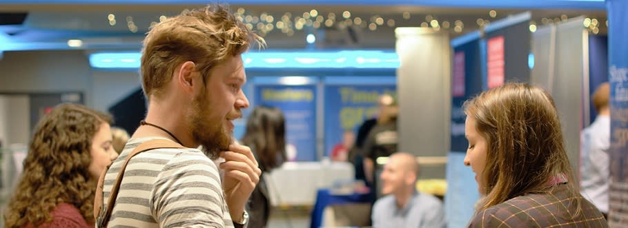 Students at a postgraduate study fair