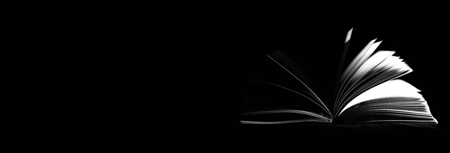 Open book with pages fluttering on black background