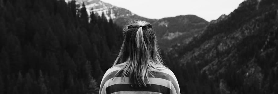 Young woman facing towards mountains