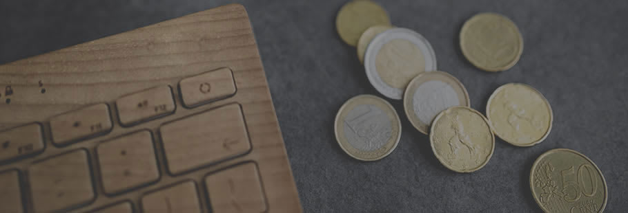 Coins on table next to keyboard