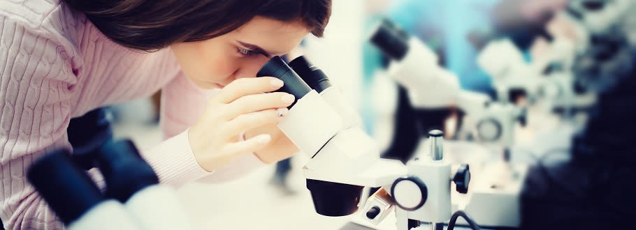 Student in lab coat with equipment Student in lab coat with equipment