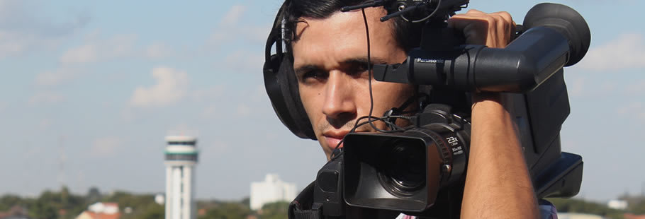 Man with video camera on shoulder