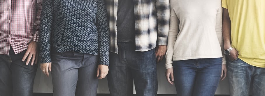 Photo of four peoples torsos.
