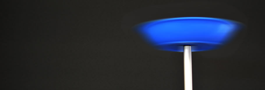 Blue plate spinning on the end of a stick