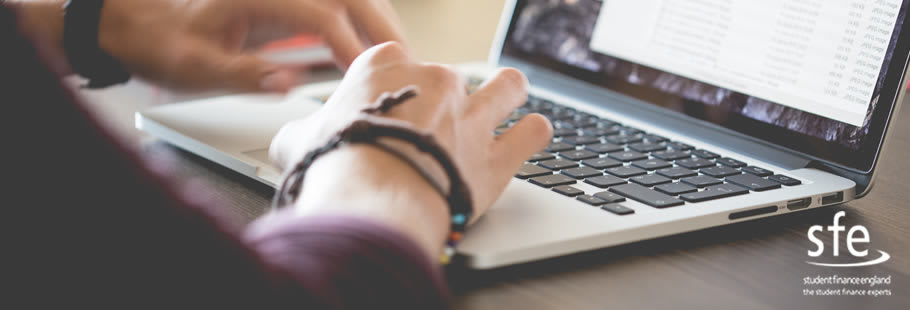 Hands at laptop keyboard