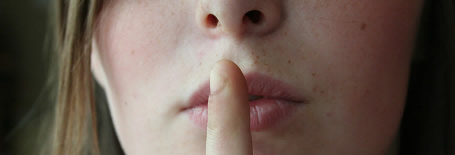 Womans face with finger on lips