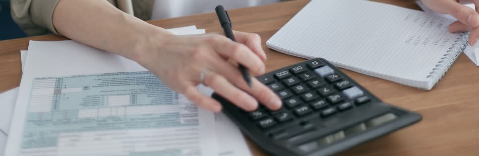 Someone using a calculator to work out student loan interest rates