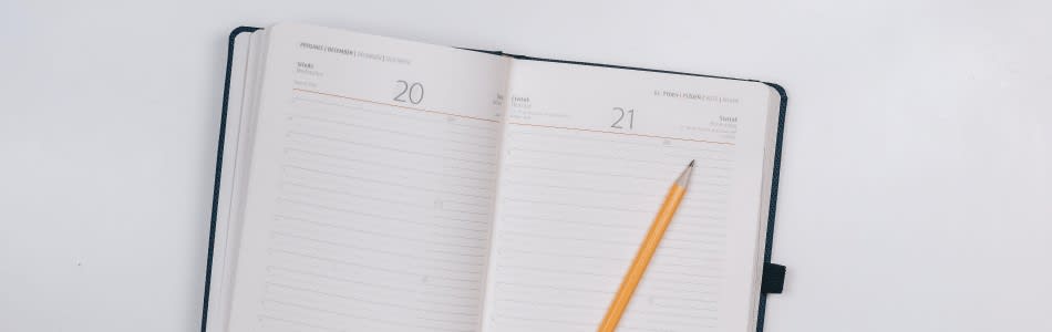 Desk with pen, paper and phone writing Masters application