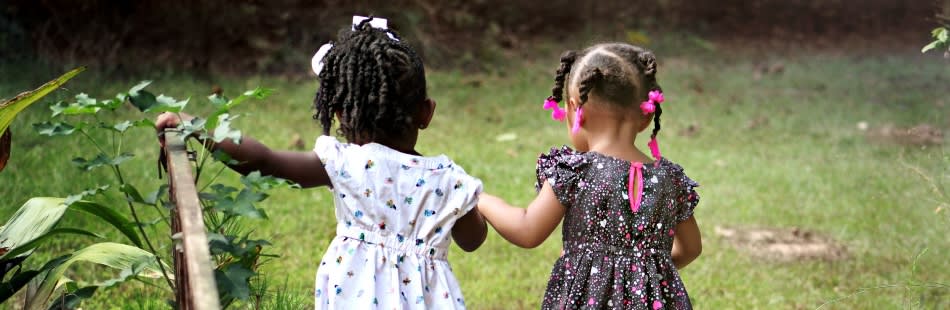 Two young girls walking away Two young girls walking away