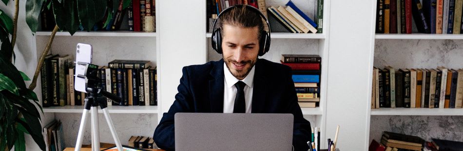 Man sat outside with laptop on table