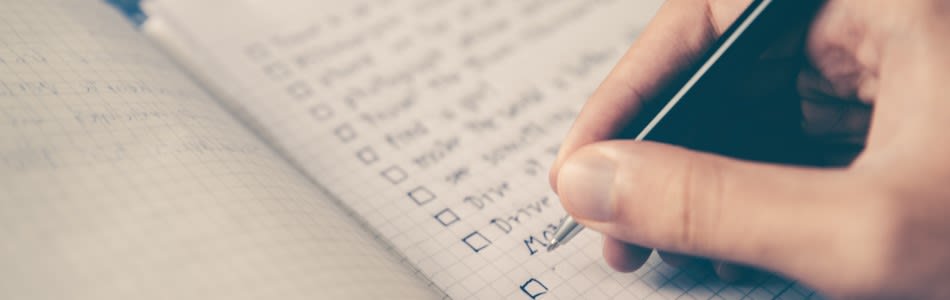 Close up of hand writing a checklist